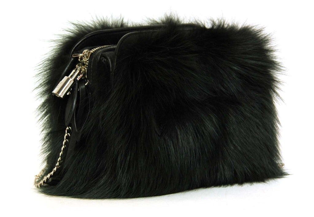 -Made of fox fur with leather trim and lining
-Made in France in 2012
-One exterior zip pocket
-Interior is separated into three compartments. Middle compartment has zip top closure and a slit pocket inside.
-Interior stamped 