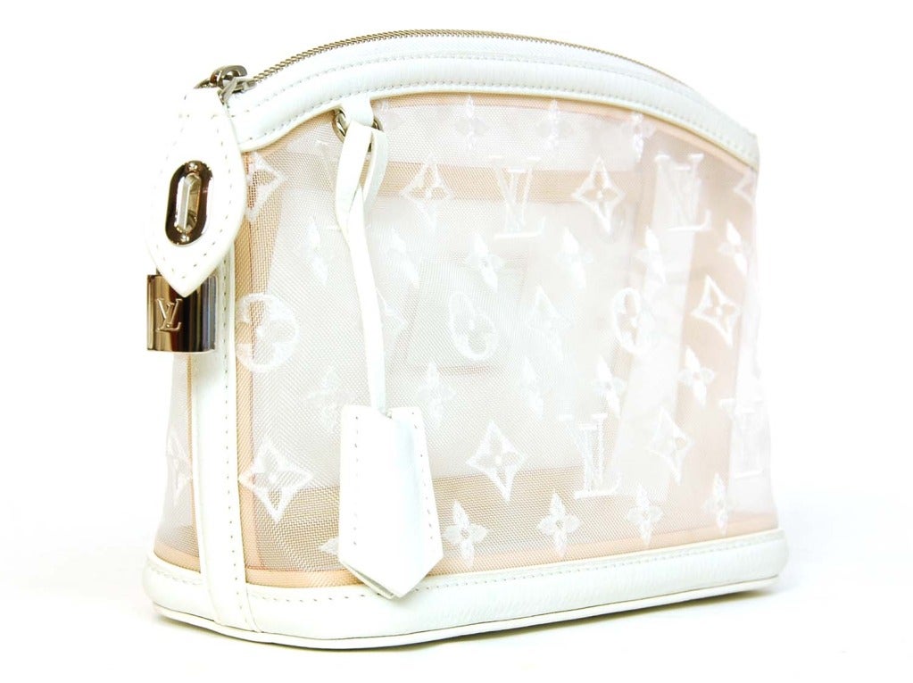 Limited edition style from Louis Vuitton.
c.2012
Made in Italy.
White sheer mesh body with stitched monogram.
White leather trim.
Silvertone hardware.
Zip to closure.
Lock hangs at side.
Leather clochette with two silver keys hangs in