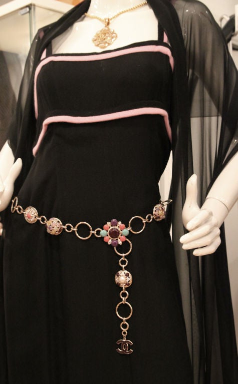 This gorgeous Chanel Necklace is sure to turn heads wherever you wear it! It features multi-color stones and rhinestones on various different shapes of charms. You could wear it as a single strand or a double strand necklace or even as a belt. Do