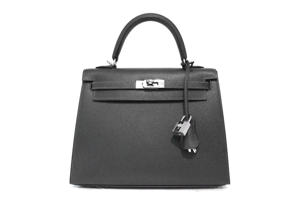 A timeless classic in a gorgeous grey colorway!<br />
<br />
Made in epsom leather with palladium hardware.<br />
<br />
Top handle with front flap and twist lock closure.<br />
<br />
Hardware on leather strap is engraved with 