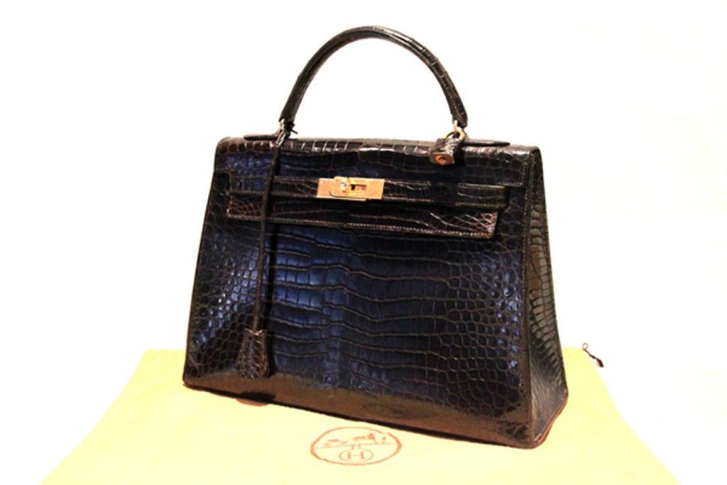 A timeless classic, this vintage Hermes Kelly Bag is a must-have addition to any Hermes lover's collection!<br />
<br />
Made in the most luxurious, espresso brown (very close to black), exotic crocodile with golden hardware.<br />
<br />
Top