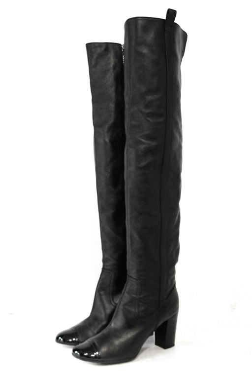 These CHANEL Black Leather Over the Knee Boots are the perfect must-have for the season!  Features black leather upper accented with patent leather toe box.  Zip closure on inner side of the boots.  Interior is lined in stain. Size marked 41, please