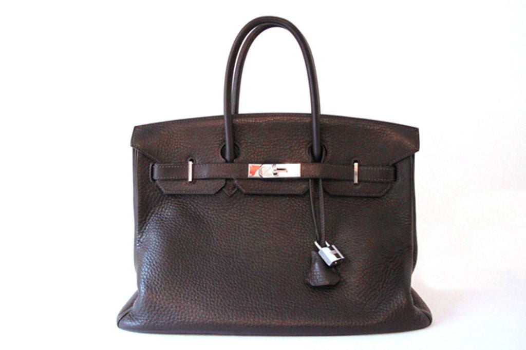 This Hermes 35cm Birkin Bag is the timeless classic and a celebrity favorite. A must-have addition to any Hermes lover's collection!<br />
<br />
Features Ebene Clemence leather with palladium hardware.<br />
<br />
Hardware on leather strap is