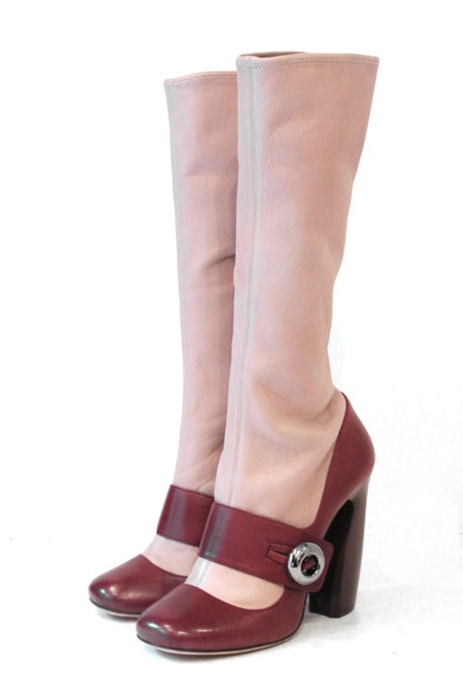 These rare, gorgeous PRADA Leather Boots were featured in the PRADA Fall/Winter 2011 Japanese Runway Show.<br />
<br />
Features raspberry leather body accented with mauve leather shaft. Strap across vamp with a pewter-tone button. Closes with