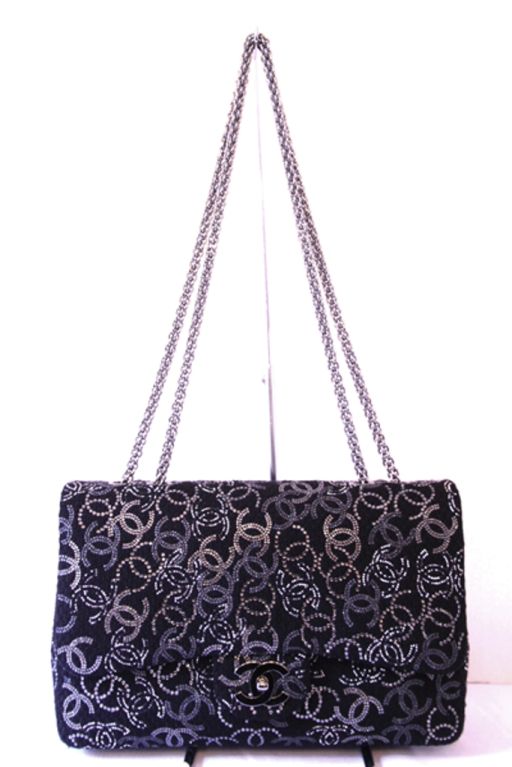 This limited edition CHANEL Black Boucle & Crystal Classic Jumbo Flag Bag is in like-new condition. Adorned with crystal CHANEL 