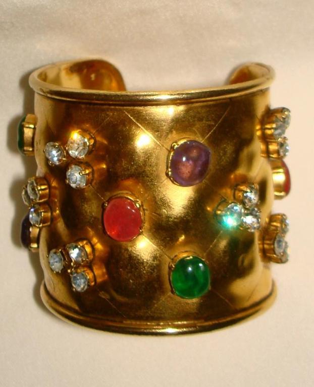 This CHANEL Cuff Bracelet is made of golden metal with clear crystals and multi color (Pink, Red, Green, Purple) poured glasses. 1.5