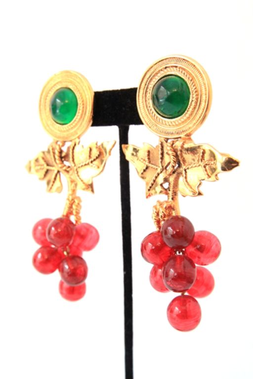 These vintage Chanel earrings are so breathtaking, they're guaranteed to turn heads wherever they're worn!<br />
<br />
Made in green and red Gripoix poured glass with golden hardware.  Golden hardware leaves, with six Gripoix grapes. 