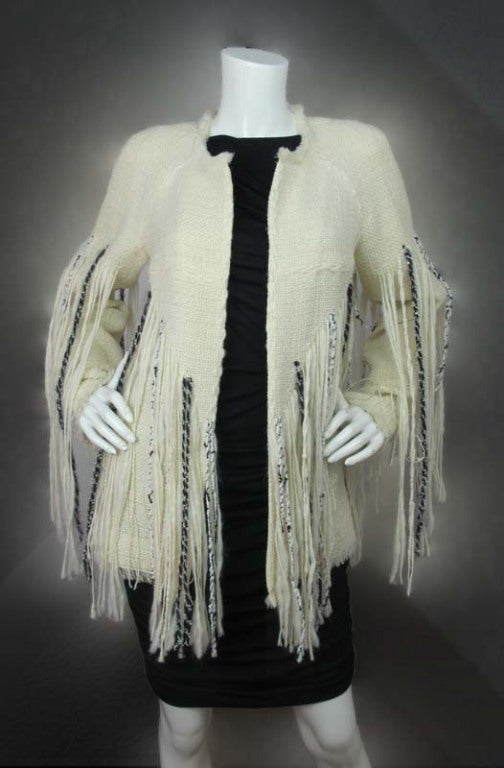 Chanel Cream Boucle Jacket With Fringes
 Made In France
 Composition: 87% Wool, 6% Cotton, 4% Nylon, 3% Other Fibers
 Marked Size 40 Estimated To Fit US Size 8

Measurements

Shoulder: 17