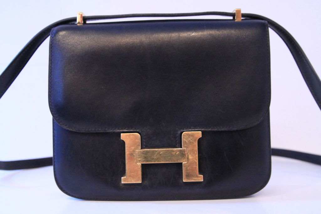 This classic HERMES Black Constance Leather Bag is a must-have for every Hermes fan or collector.  This chic bag was often carried by Jackie Kennedy-Onassis.  This elegant bag has a shoulder strap that loops through goldtone hardware at the top. 