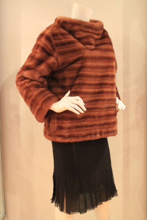 This Luxurious J. MENDEL Tan Mink Sweater Jacket is the perfect addition to any wardrobe.  Featuring elegant long sleeves, a rear zipper closure and cowl neck.  The fur is a beautifully soft mink.  Silk lined interior with two velvet lined hidden