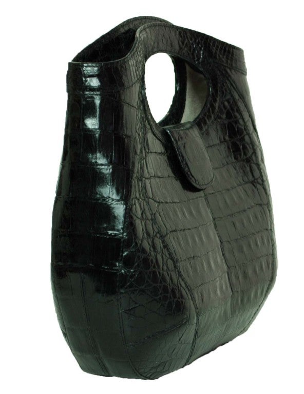 Nancy Gonzalez Black Crocodile Bag
Made In Columbia
Materials: Crocodile, Suede Lining
Interior Zipper Pocket, Slip Pocket and Cell Phone Pocket
Magnetic Closure

Measurements:
Length: 18
