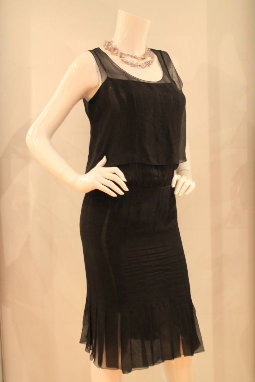 This beautiful CHANEL Black Silk Pleated Slip Dress with Sleeveless top is both elegant and classic.  The dress is made of 100% silk and sure to turn heads.  It closes with a rear snap and hook-and-eye closure.  Style number 