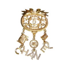 CHANEL Goldtone Brooch With Dangling Charms