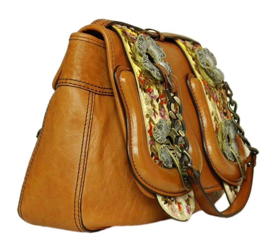 Fendi Tan Leather Double Buckle Flap Bag
Made In Italy
Materials: Leather, Fabric Embellishment
Interior Slip Pocket
Floral Design
Stamped: 