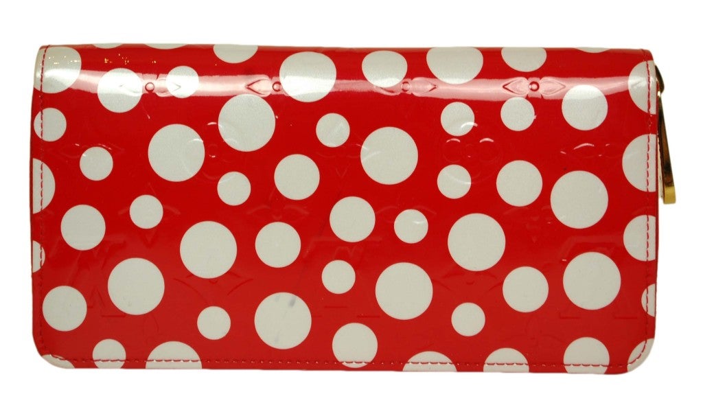 Louis Vuitton Kusama Zippy Wallet
c. 2012
Made in Spain
Part of the limited edition Yayoi Kusama collection which sold out
Red & white polka dot patent leather with red leather interior
Zippy style  
8 Credit Card slots
Date Code Reads: