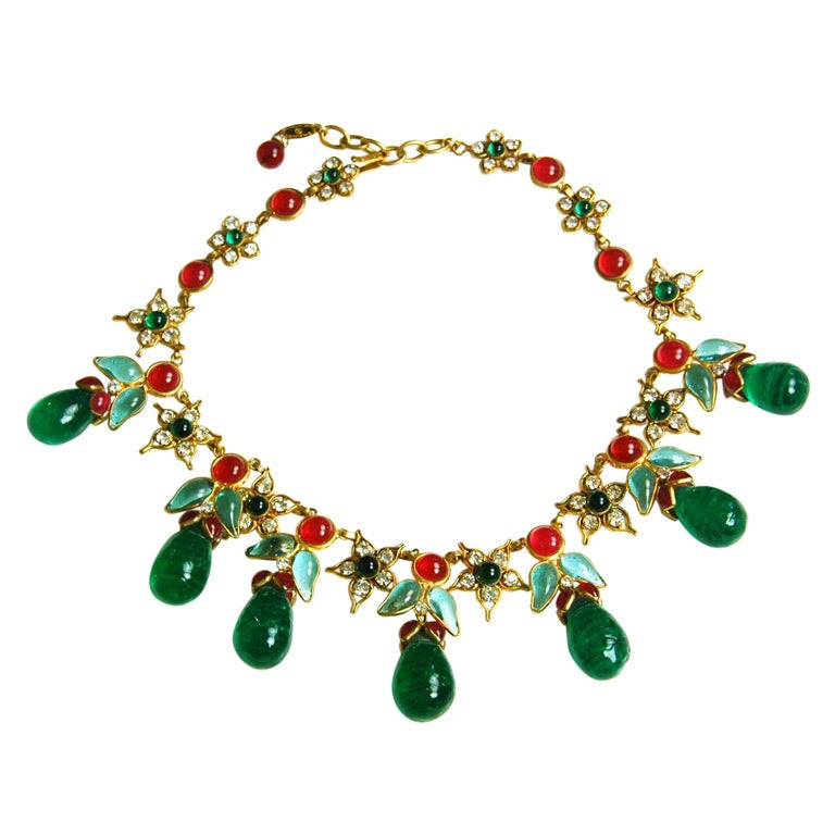 Chanel Vintage '70s Green Gripoix & Rhinestone Collar Necklace
Features flower detailing throughout

Made In: France
Year of Production: 1970's
Stamp: Chanel Made in France
Closure: Hook
Color: Green, red and goldtone
Materials: Metal, poured glass