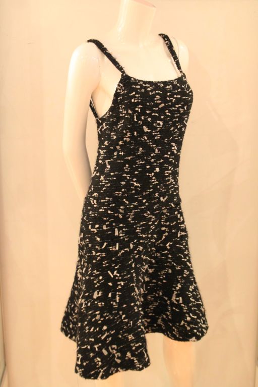 This CHANEL 02A Black and White Boucle Dress evokes the timeless and classic design of Chanel.  As part of Chanel's  2002 Autumn Collection, this dress is a must-have.  <br />
<br />
Both flirty and classic, the dress closes with a rear zipper