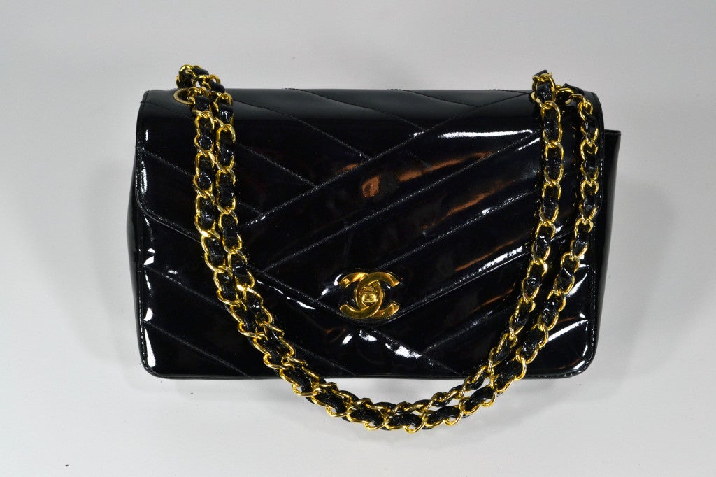 Chanel black patent leather bag with vintage gold hardware.