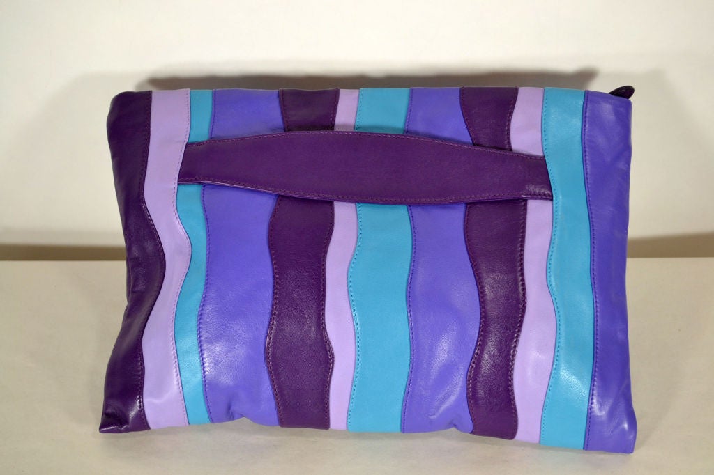 Purple striped leather clutch with zipper closure.