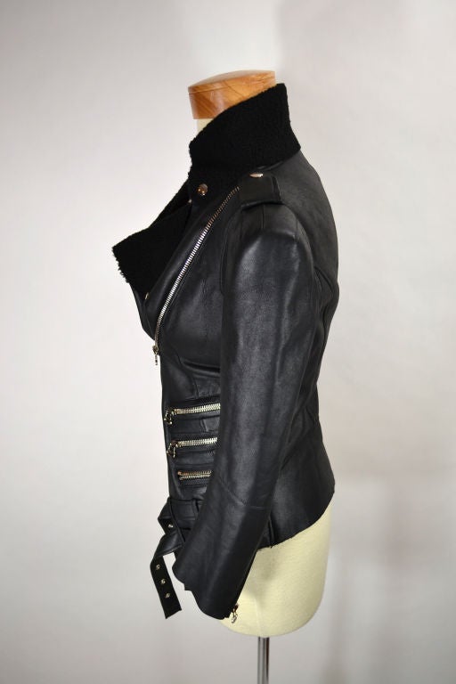 Amazing black leather shearling jacket with asymmetrical zipper and buckle closure.