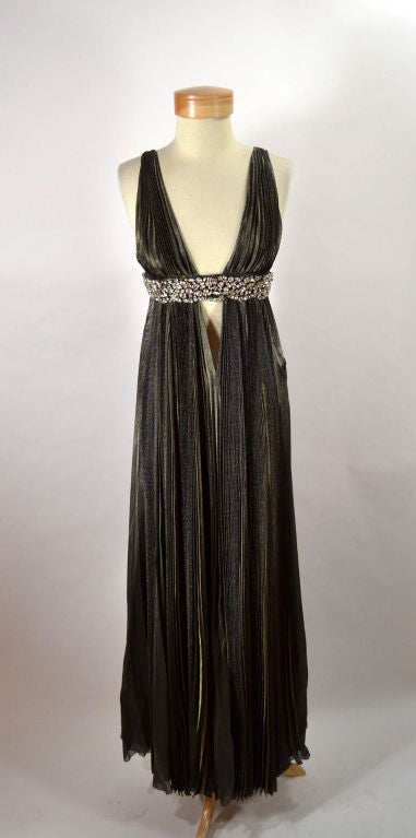 A pleated olive metallic Greecian gown with jeweled band.