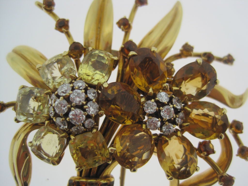 A large whimsical flower brooch consisting of yellow sapphires, diamonds and citrines by Van Cleef and Arpels. Signed and Numbered. Circa 1960.