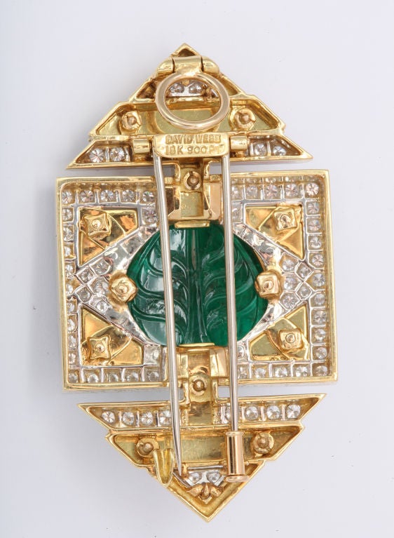 A superb pendant brooch  in the Art Deco style.Consisting of a carved Mughal Indian emerald aprox weghing 28 carats. Surrounded by diamonds and black enamel. Set on Platinum and 18 kt gold. Signed David Webb.