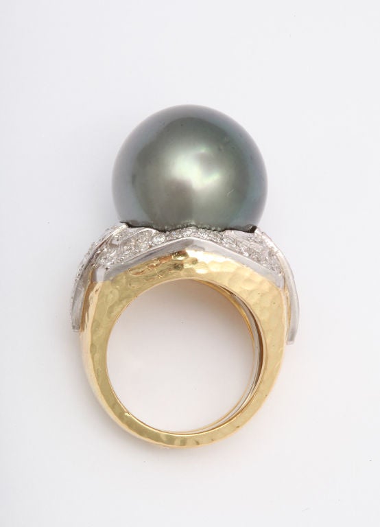 A fantastic  and impressive large cocktail ring consisting of a south sea cultured grey pearl surrounded by diamonds.  Set on 18kt hammered gold and platinum. Signed David Webb.