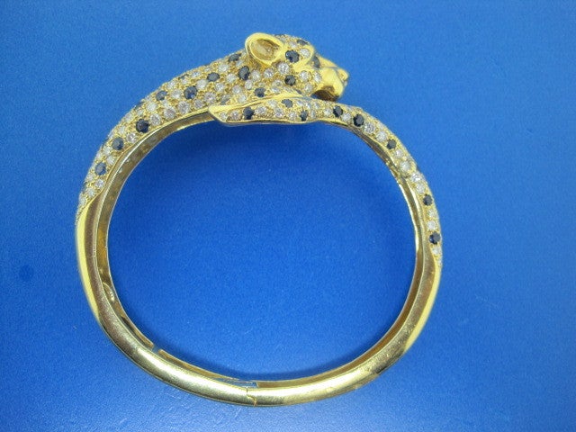 A wonderful sapphire and diamond panther bracelet set on 18k gold.
