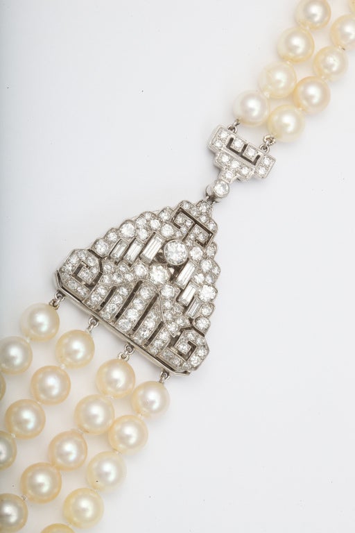 A four strand South Sea Cultured pearl necklace set with two platinum and diamond Art Deco clips- circa 1930's.