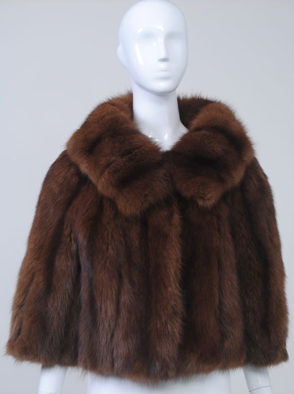 Luxurious sable jacket, the perfect cropped length, with three-quarter sleeves and a beautiful stand-up collar that can lie flat or be pulled up for extra warmth. Closes with fur hook and eye at neck, but also looks great open. Brown silk lining