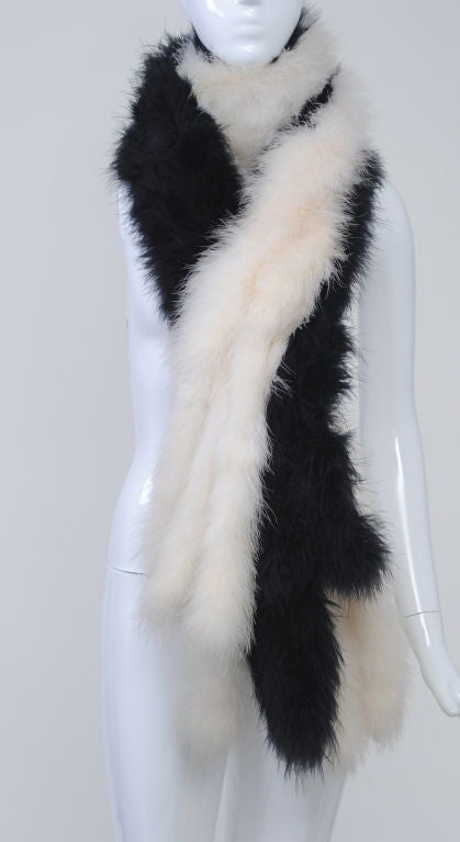 A great accent piece, this unusual boa has white marabou on one side and black on the other, each side composed of three strips of the marabou stitched to fabric, the strips extending beyond the marabou for a fringe effect.