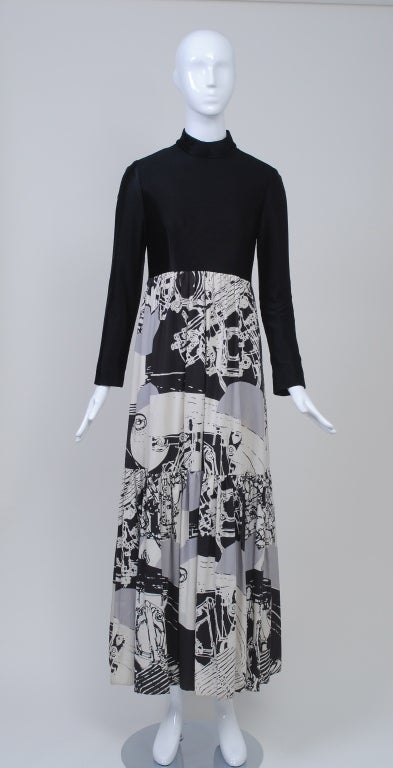 A great 1970s piece from Oscar de la Renta with a contemporary flair. The ankle-length dress features a striking abstract print skirt in gray, black, and white cotton twill that is shirred under the bodice and has a single, deep flounce. An empire