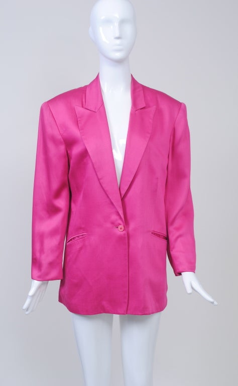 Stephen Sprouse 1980s blazer in fuchsia is is right in step with this season's brightly colored fashion statements. The jacket features a single button closure, long lapels and wide padded shoulders, as well as a single vent in back. Slash, bound