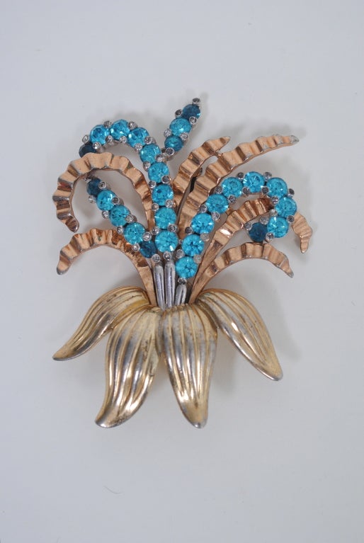 From the 1920s through the mid 1960s, Pennino produced extremely well designed and constructed costume jewelry that approximated the look of fine jewels. This large lily brooch is indicative of the company's work with its weighty casting, tricolor
