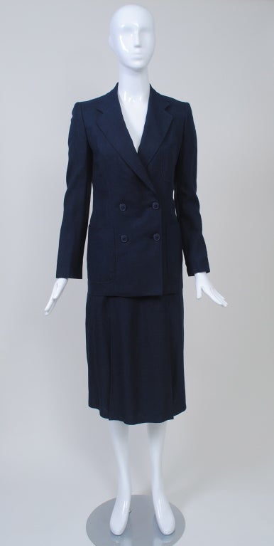 This Basile navy blazer can pair with a variety of pieces in your wardrobe, from jeans to a dress, or wear it with its accompanying skirt for business attire. Of navy linen, the long man-tailored blazer is double-breasted and has patch pockets, as