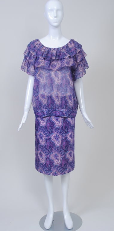 Hanae Mori purple paisley print two-piece consisting of a  straight skirt in polished cotton and a hip-length  overblouse in sheer voile. The top is blousey in style and is banded in the heavier cotton at the hip; the rounded neckline has two layers