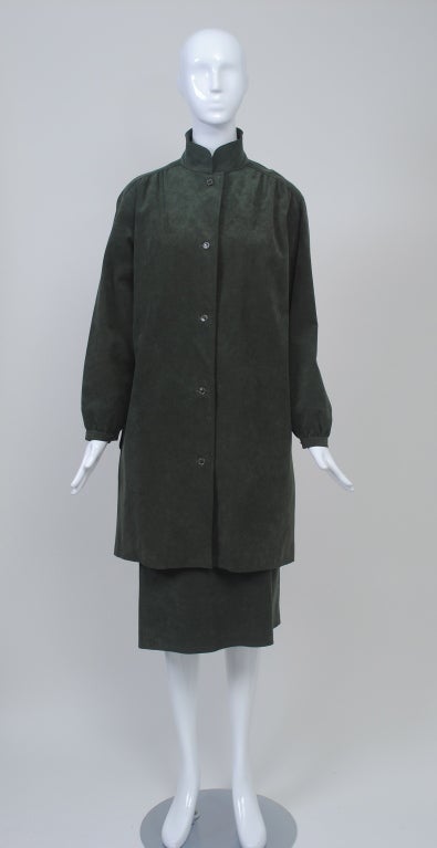 Love the soft, stone green of this ensemble, which consists of a 3/4 -length coat dress and skirt. The shirt-style coat has a convertible mandarin collar and buttons down the front; the shoulder is slightly shirred and there is a buttoned wrist.