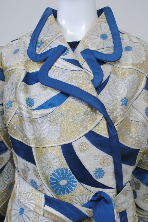 An exquisite example of Hanae Mori's early work, this ensemble demonstrates the blending of eastern and western aesthetics which characterizes her work. The coat is fashioned of a heavy gold and blue brocade that is unmistakably Japanese in