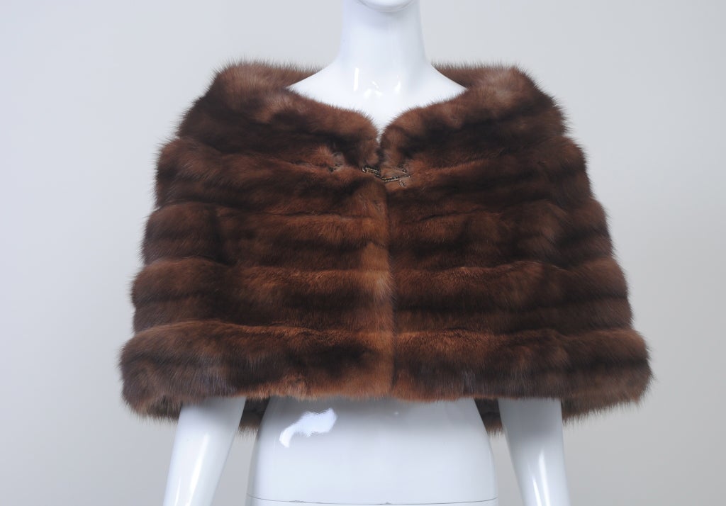 Luxurious Russian sable stole with horizontal skins and stand-up collar that frames the neckline. Clasp, in gold tone metal with black crystals, is in the style of an oversized fur hook. Lining is krinkled organza caught with tiny stitches on a
