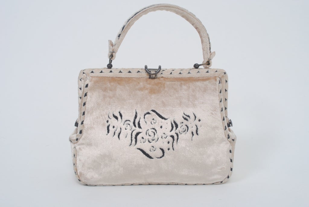 Cesare Piccini, a high-end Florentine purveyor of handbags and accessories, produced a line of velvet handbags concurrent with those of Roberta di Camerino. This example is a beige velvet satchel, the velvet voided to black for the design on front