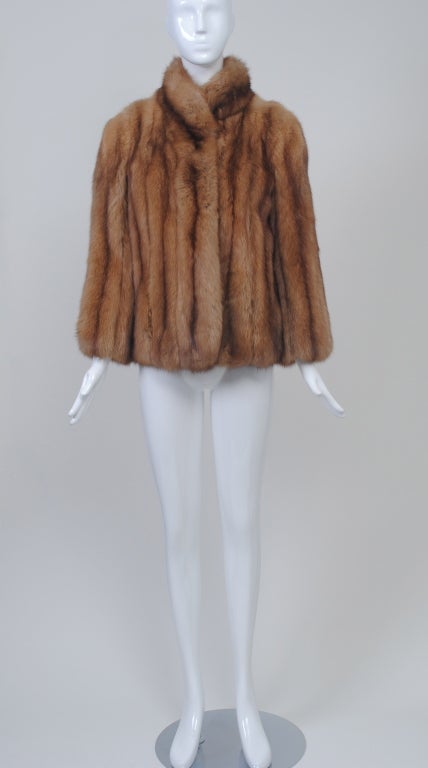 Who can resist? Luxuriate in this beautiful golden sable jacket from Revillon, one of the renowned furriers of our time. A simple style to show off the skins, which are vertical on body and sleeves. The jacket features a stand-up collar, slit