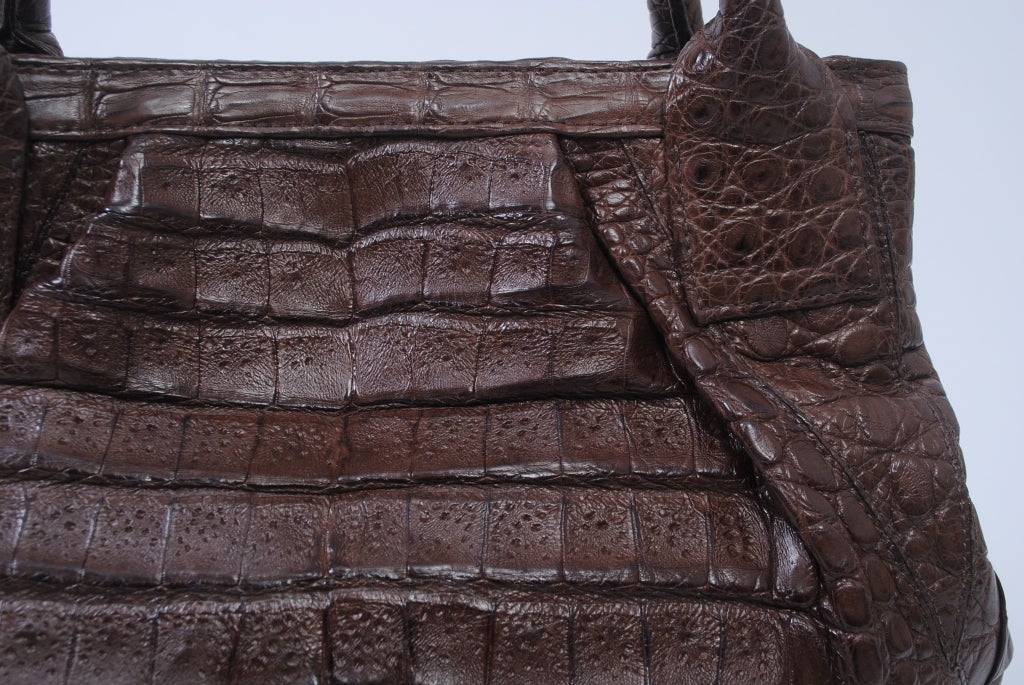 LAI light brown crocodile double-handled satchel with pleated detail front and back.  Roomy linen interior with multiple side compartments - zip compartment on each side plus open compartments for  cell phone, etc. Magnetic snap closure.


Luxury