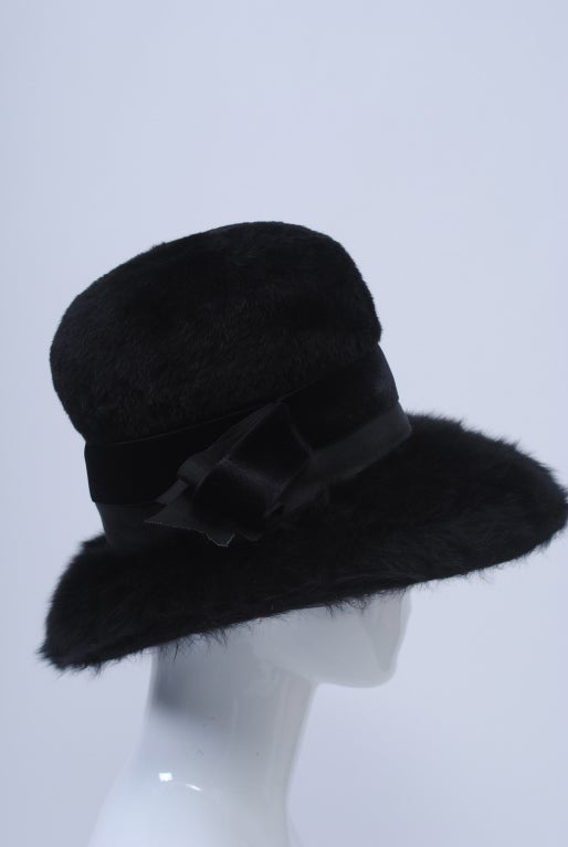 1960s high-crown hat with wide brim and double grosgrain/velvet band in long-hair felted wool.