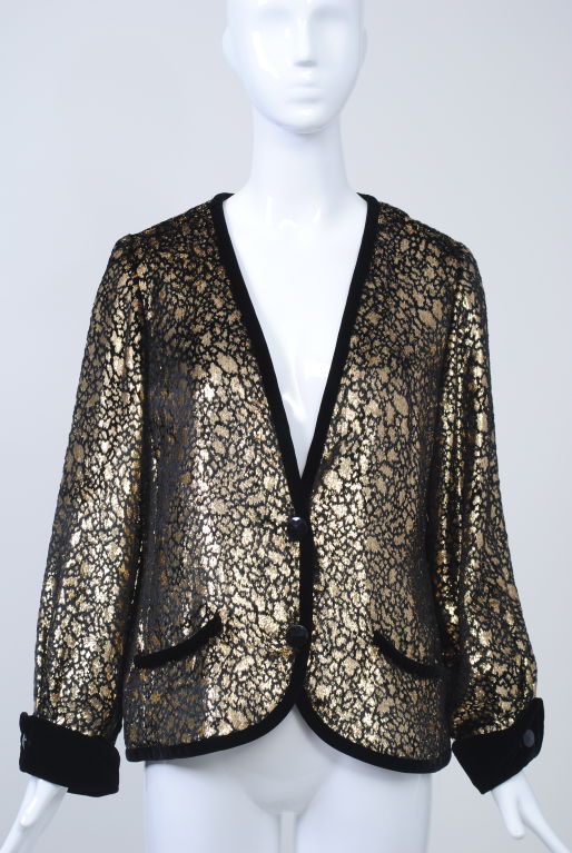 The emphasis is on the fabric of this simply styled Valentino '80s jacket. Gold metallic-stamped black velvet for the body is bordered by black velvet edging all around and defines the curved slash pockets. Deep V neckline, black velvet turn-back