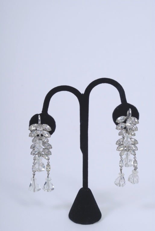 Stunning pair of rhinestone earrings that cascade both in front and back of the earlobe. Composed of marquise-cut rhinestones that terminate in cut crystal drops. A glamorous and unusual look. Unmarked.