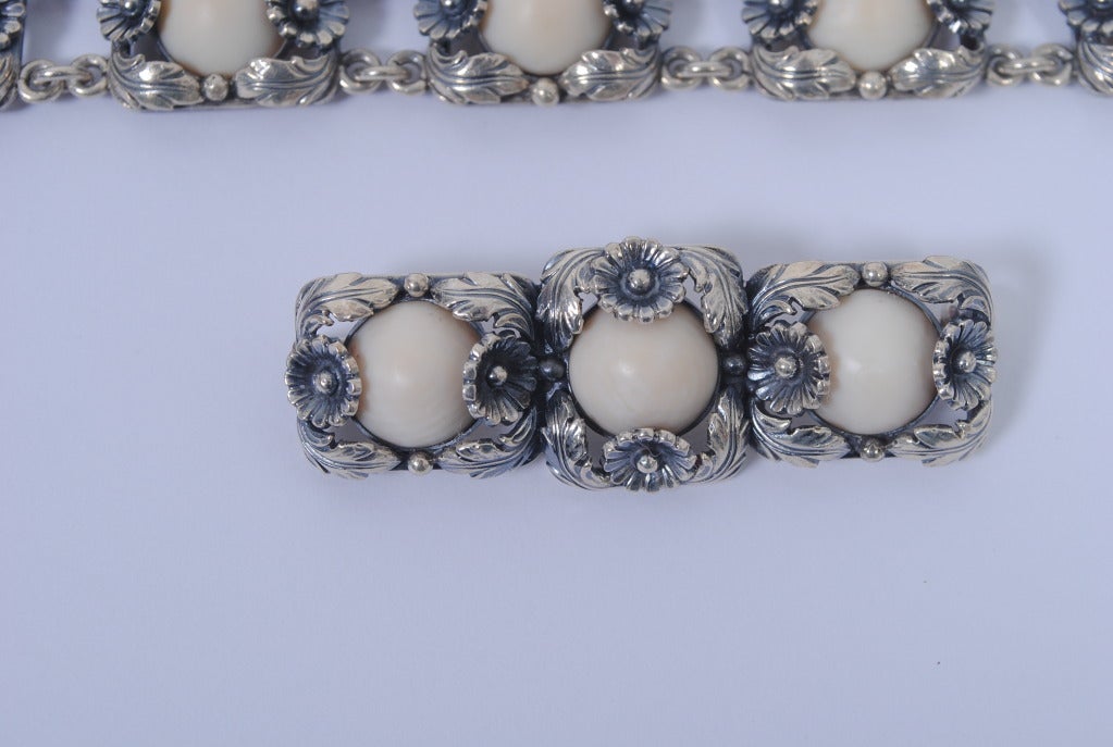 Mid-century sterling bracelet and brooch from Denmark's N.E. From. The design is composed rectangular sterling links of leaves and flowers, each centering an ivory cabochon. The bracelet consists of seven links, the brooch three. Both pieces marked