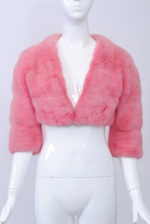 What a find! 1960s mink bolero dyed bubblegum pink - a unique vintage piece with a contemporary aesthetic and fit. Cropped V-neck style with three-quarter sleeves. One fur-hook closure. Lined in pink silk. Approximate size 4-6.