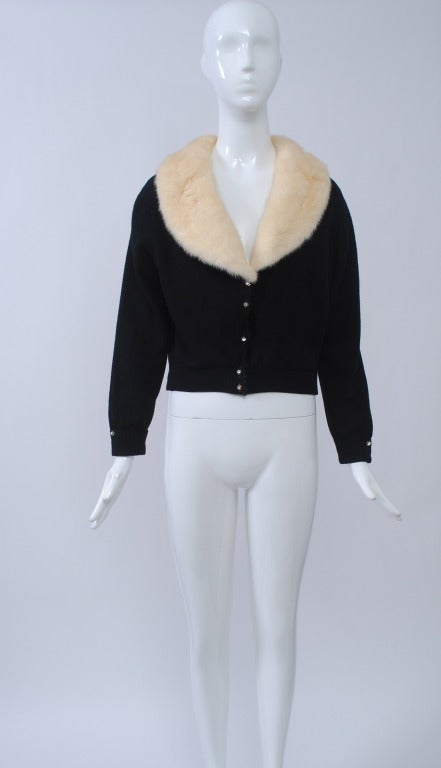 Black cashmere cardigan with V neck trimmed in white mink. Velvet edging down front with rhinestone buttons there and at wrists. Lined. Size S-M.