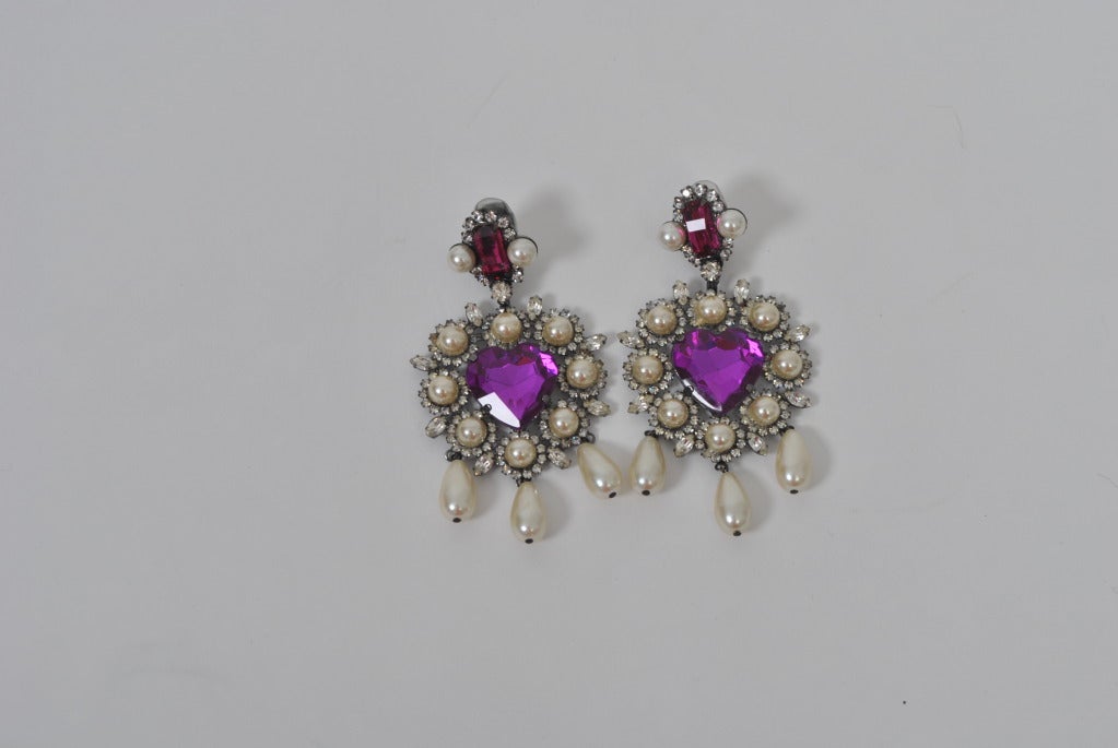 Larry Vrba large drop earrings with heart-shaped purple crystal at center surrounded by pearls in rhinestones and and with 3 pearl drops at bottom. The earpiece has a raspberry colored faceted oval crystal outlined in small rhinestones and a pearl